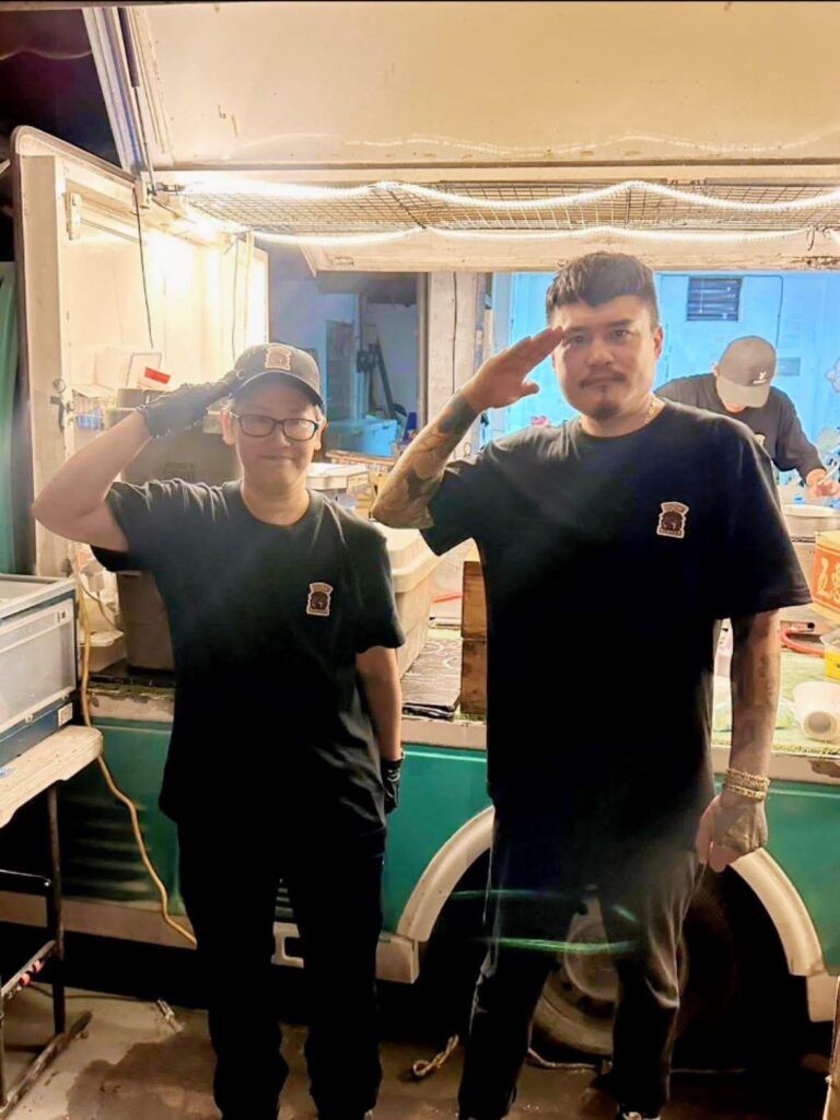 Taiwan food truck staff preparing free burgers for volunteers